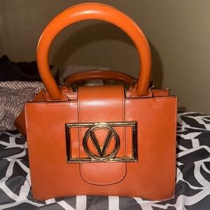 Valentino barely used. warm brown color, accessorize with earth tones.